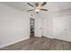 A well-lit bedroom with wood-look floors, a ceiling fan, and closet, offering storage at 8238 E San Miguel Ave, Scottsdale, AZ 85250