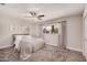 Cozy bedroom featuring plush carpet, a ceiling fan, neutral walls and a window for natural light at 8238 E San Miguel Ave, Scottsdale, AZ 85250