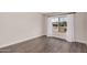Well-lit bedroom with hardwood flooring and a window with white curtains providing neighborhood views at 8238 E San Miguel Ave, Scottsdale, AZ 85250