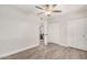Open bedroom layout with hardwood floors, a ceiling fan, closet space and view to an adjacent room at 8238 E San Miguel Ave, Scottsdale, AZ 85250