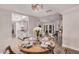 Elegant dining room with seating for four, leading into an open concept kitchen and living area at 8238 E San Miguel Ave, Scottsdale, AZ 85250