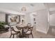 Inviting dining area with a round table, modern chandelier, and an open layout to the kitchen at 8238 E San Miguel Ave, Scottsdale, AZ 85250