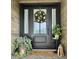 Stylish black front door framed by sidelights and adorned with a festive wreath for a welcoming entrance at 8238 E San Miguel Ave, Scottsdale, AZ 85250