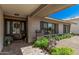 Inviting home entrance with wood accents, stylish door, and lovely landscaping enhancing curb appeal at 8238 E San Miguel Ave, Scottsdale, AZ 85250