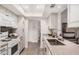 Modern kitchen with granite countertops, white cabinets, and stainless steel appliances at 8238 E San Miguel Ave, Scottsdale, AZ 85250