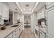 Well-lit kitchen featuring white cabinets, granite countertops, and modern appliances, ideal for cooking and entertaining at 8238 E San Miguel Ave, Scottsdale, AZ 85250