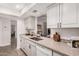 Updated kitchen featuring granite counters, mosaic backsplash, and stainless steel sink at 8238 E San Miguel Ave, Scottsdale, AZ 85250