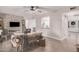 Stylish living area boasts a brick accent wall, modern furniture, and an open layout with seamless transition to dining at 8238 E San Miguel Ave, Scottsdale, AZ 85250