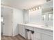 Bright white bathroom featuring double vanity and under cabinet storage at 8438 E Stella Ln, Scottsdale, AZ 85250