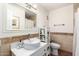 Stylish bathroom featuring travertine accents, modern fixtures, a white vanity, and a large mirror at 8438 E Stella Ln, Scottsdale, AZ 85250