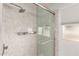 Modern bathroom boasting a marble-look glass shower with a chrome showerhead at 8438 E Stella Ln, Scottsdale, AZ 85250