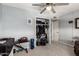 Bedroom featuring neutral paint, ceiling fan, an open closet and workout gear, creating a flexible space at 8438 E Stella Ln, Scottsdale, AZ 85250