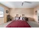 Neutral bedroom with a ceiling fan, double bed, and a large window at 8438 E Stella Ln, Scottsdale, AZ 85250