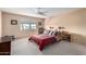 This bedroom features neutral walls and carpet, a ceiling fan, and a window at 8438 E Stella Ln, Scottsdale, AZ 85250