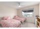 Cozy bedroom featuring two beds, neutral walls, carpet and a ceiling fan at 8438 E Stella Ln, Scottsdale, AZ 85250