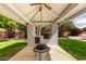 Outdoor grilling station with built-in features and a lush lawn, ideal for outdoor cooking and entertainment at 8438 E Stella Ln, Scottsdale, AZ 85250