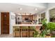 Kitchen featuring barstool seating, tile flooring and stainless steel refrigerator at 8438 E Stella Ln, Scottsdale, AZ 85250