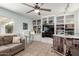 Relaxing living room with built-in bookshelves, tile flooring, and a comfortable couch, perfect for entertaining or unwinding at 8438 E Stella Ln, Scottsdale, AZ 85250