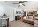 Open-concept living room with a bar area, comfortable seating, and tile floors, perfect for relaxing and socializing at 8438 E Stella Ln, Scottsdale, AZ 85250