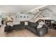 Cozy living room features a large sectional couch, stairs, and tile flooring, creating an inviting and comfortable atmosphere at 8438 E Stella Ln, Scottsdale, AZ 85250