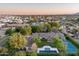 Stunning aerial view showcasing the property's backyard pool, tennis court, and lush green surroundings at 8602 E Gary Rd, Scottsdale, AZ 85260