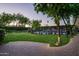 Spacious backyard with lush green lawn, mature trees, pool, and paved patio area at 8602 E Gary Rd, Scottsdale, AZ 85260