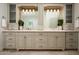 Elegant bathroom featuring double vanity with marble countertop, decorative mirrors, and sconce lighting at 8602 E Gary Rd, Scottsdale, AZ 85260