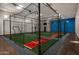 Indoor batting cage with netting, artificial turf, and pitching mound for training purposes at 8602 E Gary Rd, Scottsdale, AZ 85260