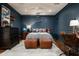 Bedroom featuring decorative pillows, wood floors, classic lamps, and dark blue walls at 8602 E Gary Rd, Scottsdale, AZ 85260