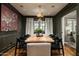 Well-lit dining room with a large wooden table, seating for eight, and stylish decorative art at 8602 E Gary Rd, Scottsdale, AZ 85260