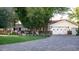 Beautiful home exterior with mature trees, manicured lawn, and brick driveway at 8602 E Gary Rd, Scottsdale, AZ 85260
