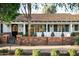 Charming home exterior featuring a brick patio, white pillars, and manicured bushes at 8602 E Gary Rd, Scottsdale, AZ 85260
