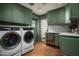 Stylish laundry room with modern washer and dryer, updated sink, and wood floors at 8602 E Gary Rd, Scottsdale, AZ 85260