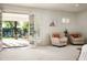 Cozy living room with bright light from patio, plush chairs, and elegant shutters at 8602 E Gary Rd, Scottsdale, AZ 85260