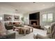 Inviting living room with a brick fireplace, plush seating, and large wall-mounted television at 8602 E Gary Rd, Scottsdale, AZ 85260