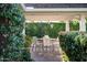 Outdoor dining under a covered patio with privacy hedges and basketball court at 8602 E Gary Rd, Scottsdale, AZ 85260