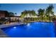 Stunning pool featuring a fountain and ambient blue lighting perfect for evening swims and outdoor enjoyment at 8602 E Gary Rd, Scottsdale, AZ 85260