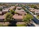 Aerial view shows houses with desert landscaping and ponds in the neighborhood at 897 E Cherry Hills Dr, Chandler, AZ 85249