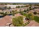 Aerial view of homes with red tile roofs in a neighborhood with mature trees and landscaping at 897 E Cherry Hills Dr, Chandler, AZ 85249