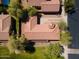 Aerial view shows houses with well maintained yards and mature trees, and unique turret roof at 897 E Cherry Hills Dr, Chandler, AZ 85249