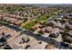 Aerial view shows the houses, yards, landscaping and a park with mature trees within the neighborhood at 897 E Cherry Hills Dr, Chandler, AZ 85249