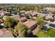 Aerial view of the houses with desert landscaping and a nearby neighborhood pond at 897 E Cherry Hills Dr, Chandler, AZ 85249