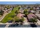 Expansive aerial view of a desert community showcasing lush green spaces and numerous single-Gathering homes at 897 E Cherry Hills Dr, Chandler, AZ 85249