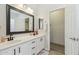 Double sink bathroom with white cabinets, modern fixtures, framed mirror and walk-in closet at 897 E Cherry Hills Dr, Chandler, AZ 85249