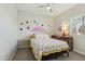 Cozy bedroom featuring cherry-themed decorations, ceiling fan, natural lighting, and bedside furnishings at 897 E Cherry Hills Dr, Chandler, AZ 85249