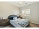 Inviting bedroom featuring ceiling fan, plush bedding, and cozy decor at 897 E Cherry Hills Dr, Chandler, AZ 85249