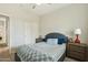 Comfortable bedroom featuring ceiling fan, plush bedding, and closet space at 897 E Cherry Hills Dr, Chandler, AZ 85249