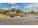 Planned community entrance, featuring manicured landscaping, signage, and an American flag at 897 E Cherry Hills Dr, Chandler, AZ 85249