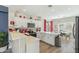 Bright kitchen featuring white cabinetry, modern appliances, and a breakfast bar overlooking the dining area at 897 E Cherry Hills Dr, Chandler, AZ 85249