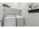Clean laundry room with shelving, decorations and a standard washer and dryer set at 897 E Cherry Hills Dr, Chandler, AZ 85249